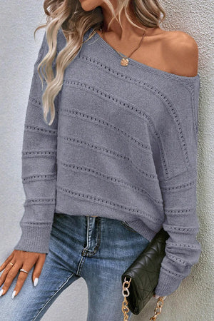Gray off-the-shoulder knit pullover sweater with openwork detail and boat neckline.