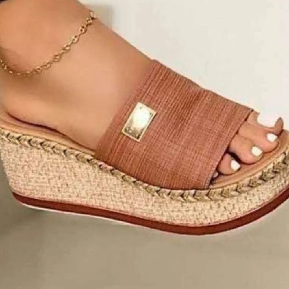 Caramel textured platform slides with metallic detail and espadrille sole.