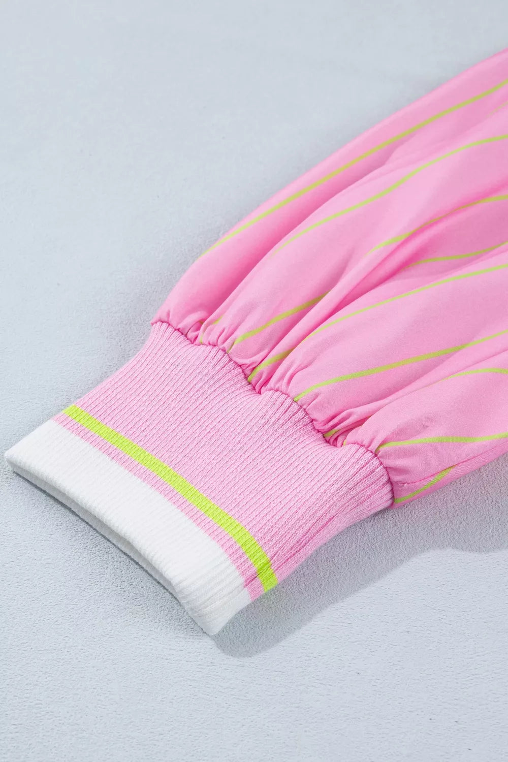 Pink striped polo shirt sleeve with ribbed cuff and contrast trim