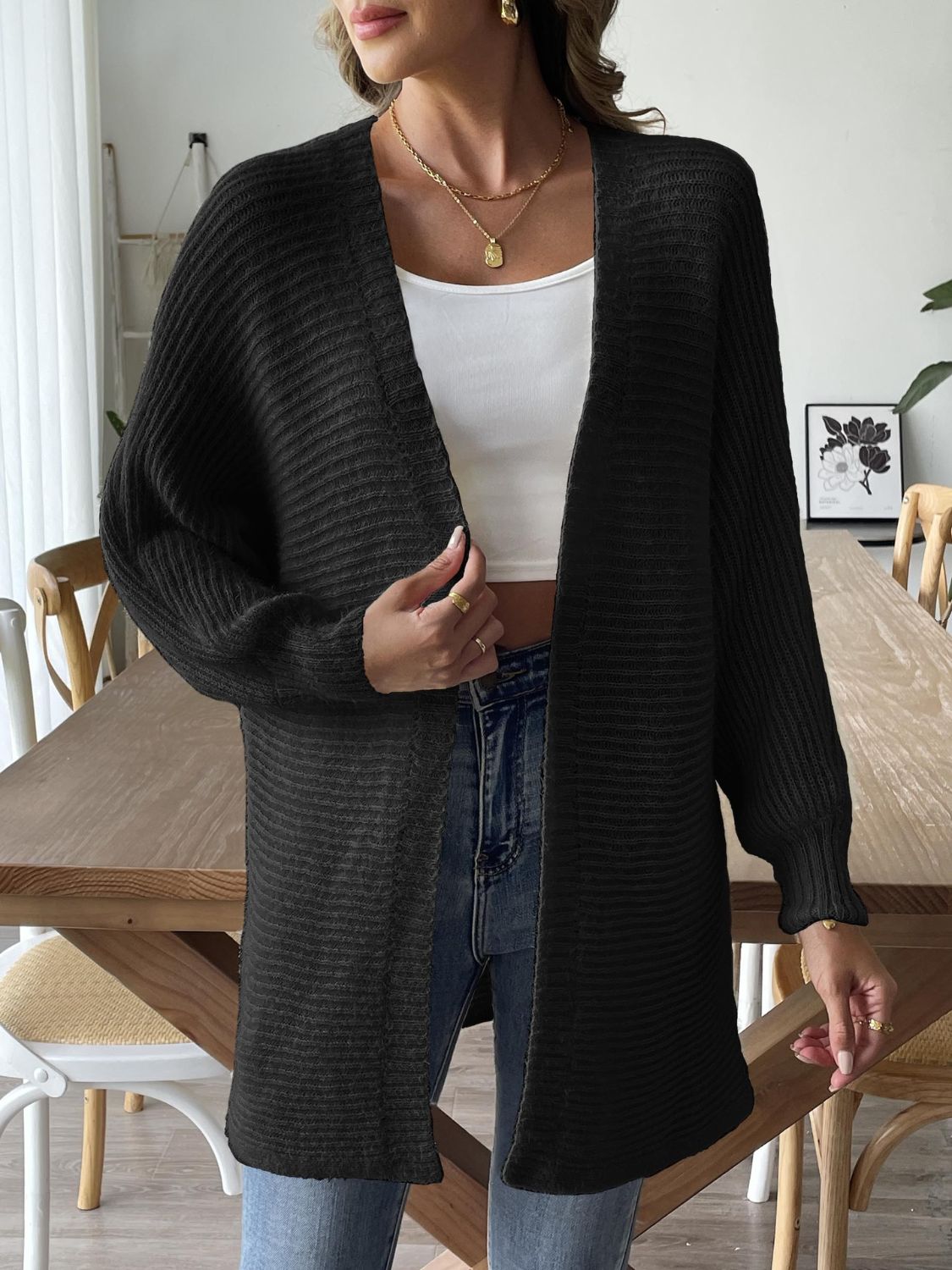 Black ribbed knit dolman sleeve cardigan with open front and long sleeves.