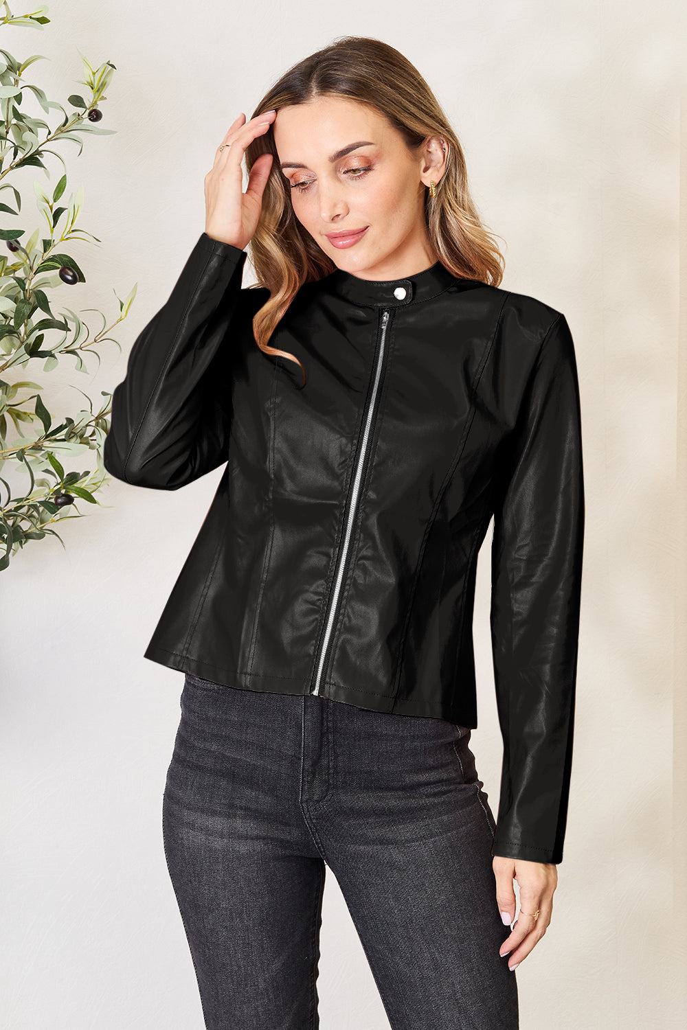 Black faux leather biker jacket with zip front and stand collar.