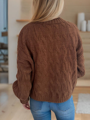 Oversized caramel cable knit turtleneck sweater with ribbed cuffs and hem.