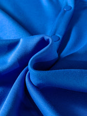 Vibrant blue polo shirt with button detail and soft fabric texture