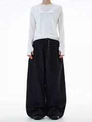 Black plus size wide-leg sweatpants with button details and a belted waist.