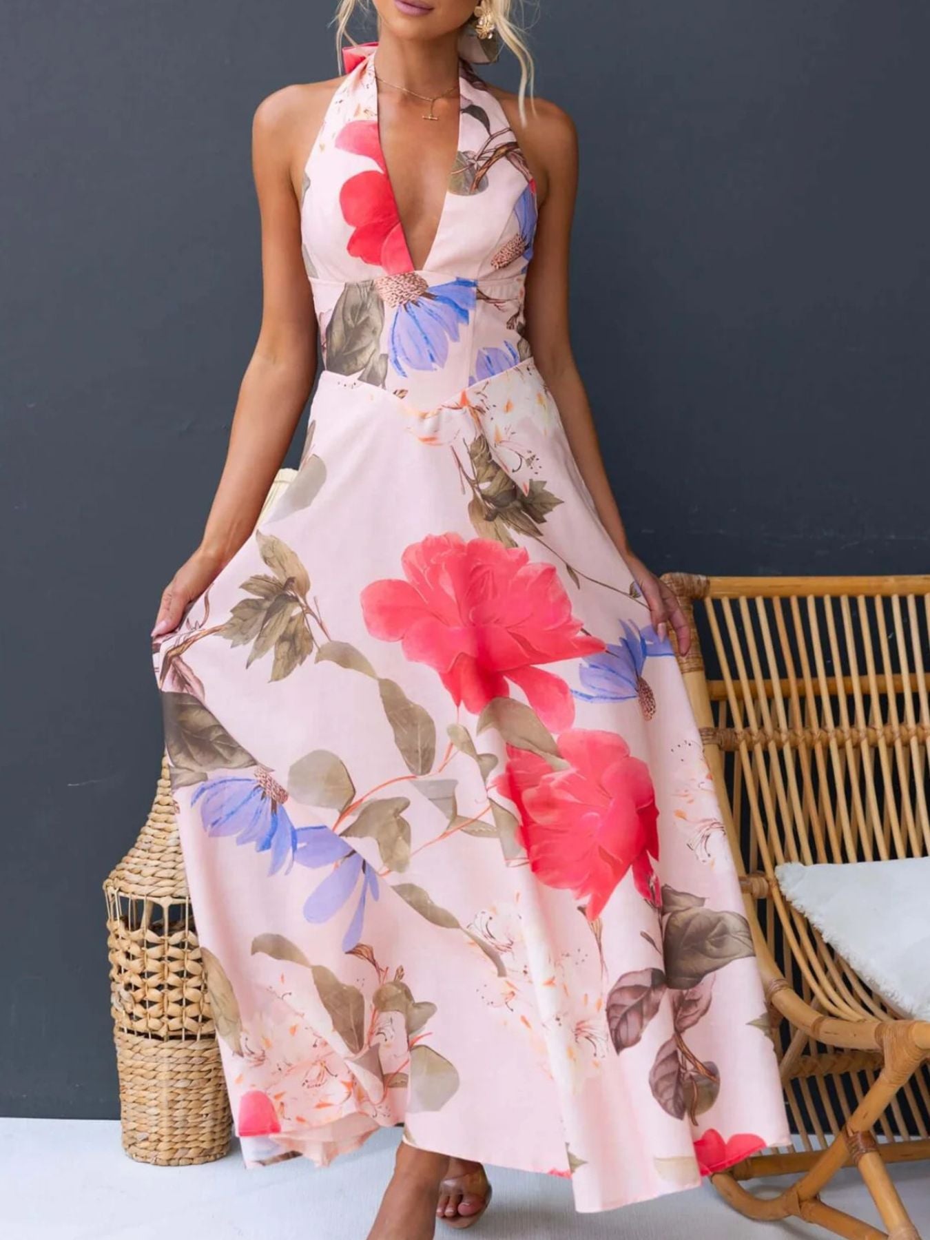 Pink floral halter neck maxi dress with a deep V-neck and a-line skirt.