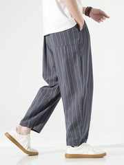 Men's grey striped relaxed fit sweatpants with drawstring and pockets.