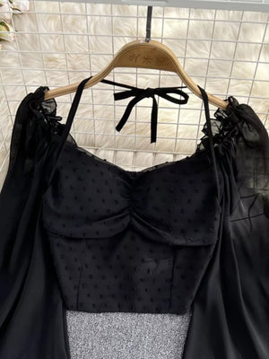 Black Swiss dot maternity blouse with ruffled neckline and tie halter.