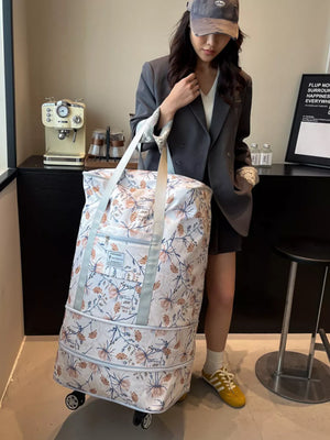 Charming Floral Rolling Travel Bag in white with a floral pattern, featuring wheels and handles.