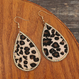 Leopard print teardrop earrings with crystal trim and gold hooks.