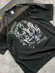 Black distressed graphic tee with skull print and ripped details.