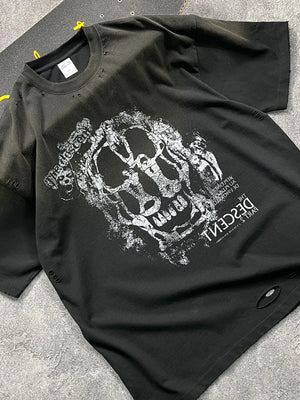 Black distressed graphic tee with skull print and ripped details.
