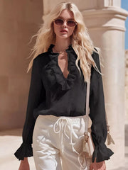 Black V-neck maternity shirt with ruffled neckline and cuffs.