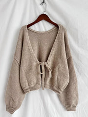 Textured tie-front knit cardigan in khaki with a deep V-neck and balloon sleeves.