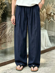 Dark blue wide-leg sweatpants with drawstring and front pleats.