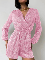 Pink sequin wrap romper with blouson sleeves and a V-neckline.