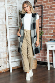 Geometric knit duster vest in black and tan checkered pattern with pockets.