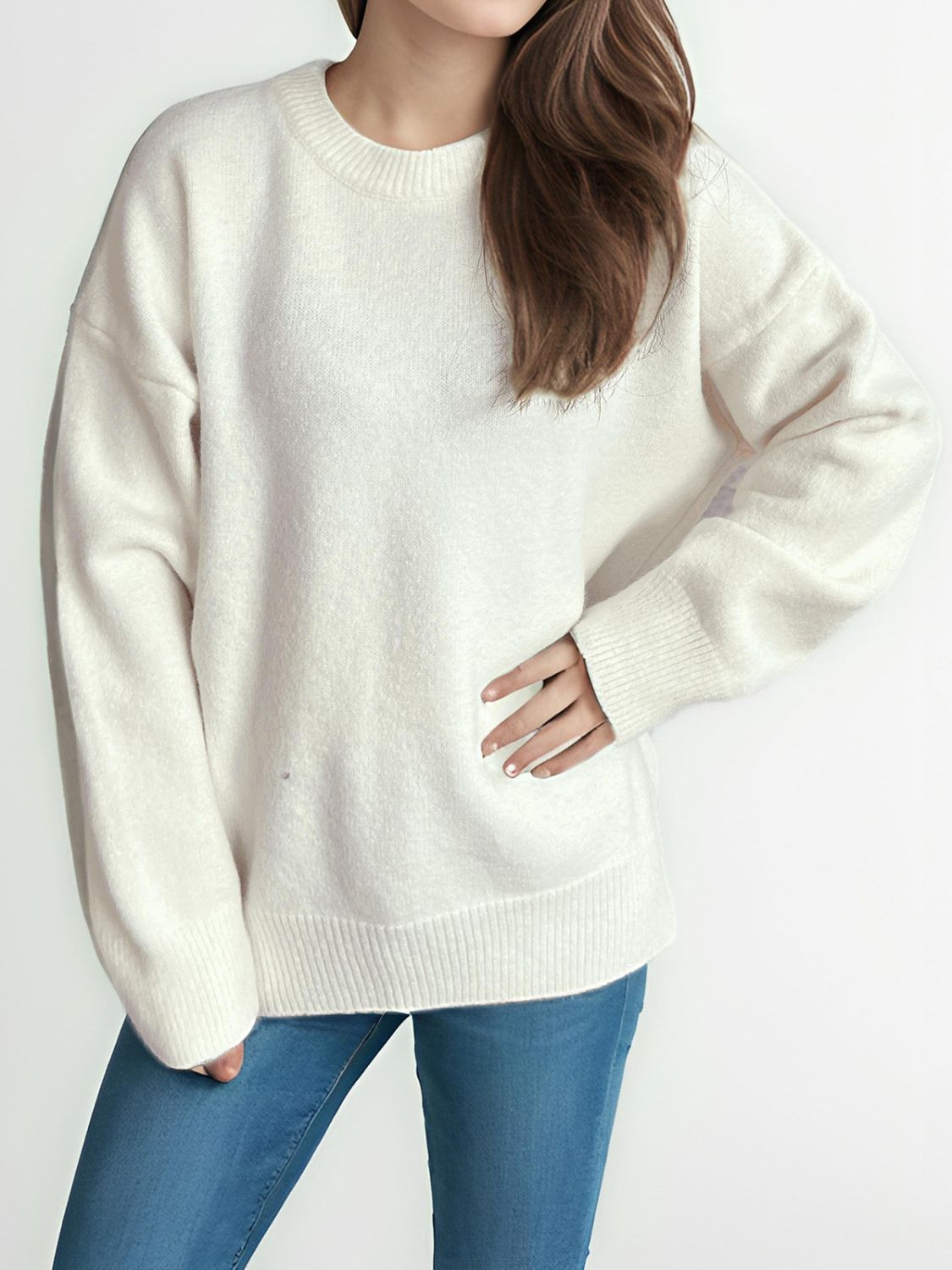 Oversized crewneck knit pullover sweater in white with ribbed cuffs and hem.