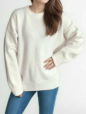 Oversized crewneck knit pullover sweater in white with ribbed cuffs and hem.