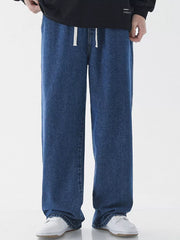 Relaxed wide-leg jeans in light blue denim with a white drawstring waist.