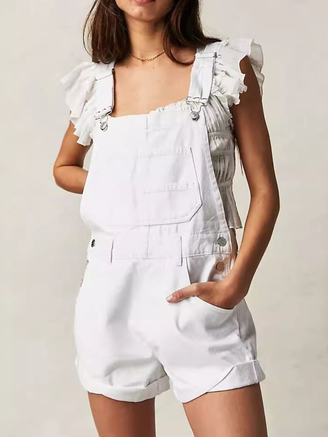White denim short overalls with square neckline and cuffed hems