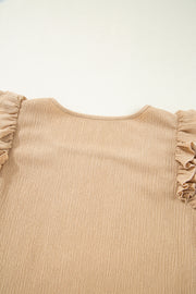 Tan textured blouse with ruffled short sleeves and square neckline.