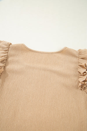 Tan textured blouse with ruffled short sleeves and square neckline.