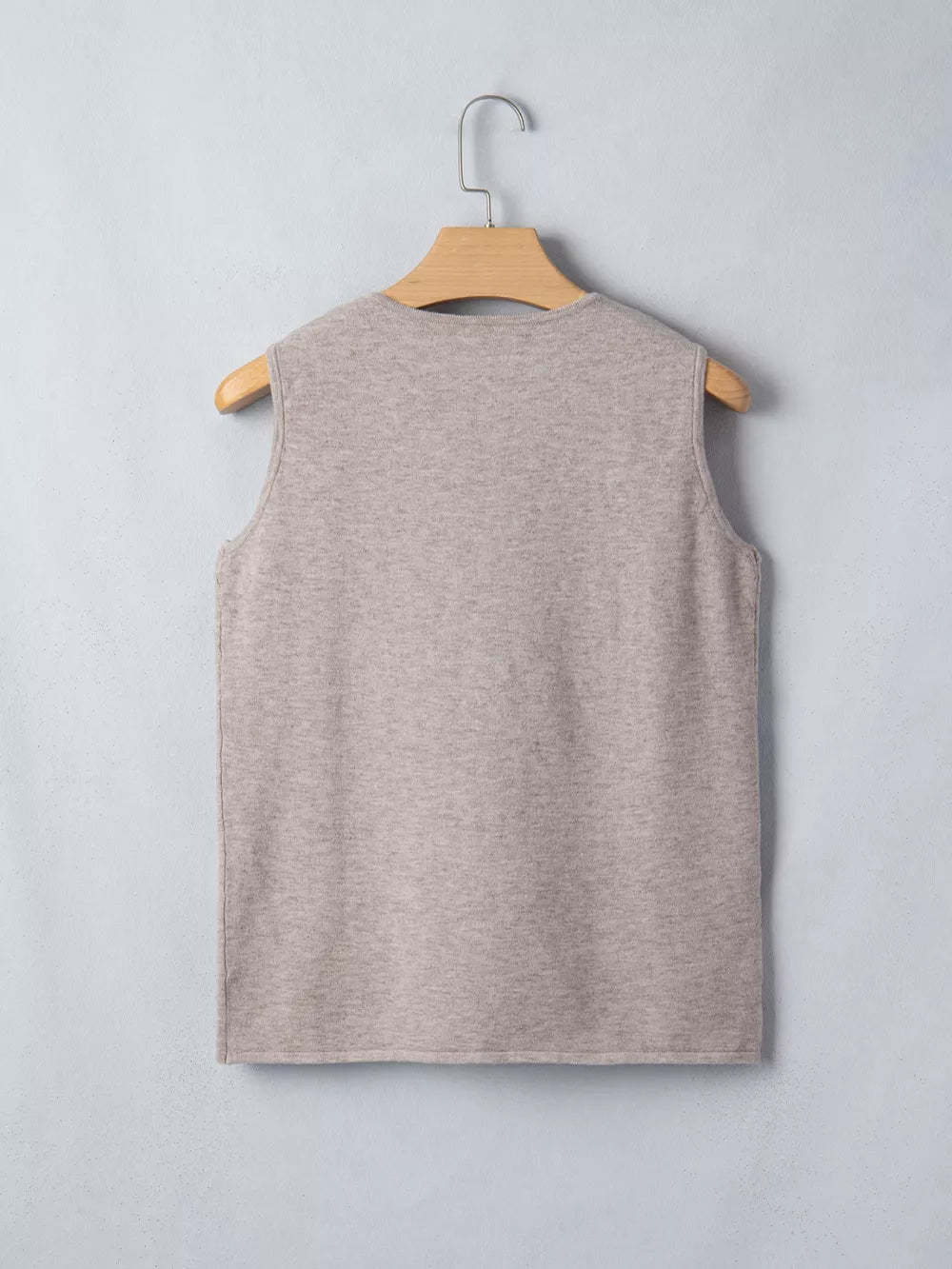 Beige V-neck knit vest with star embellishments, sleeveless acrylic.