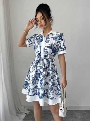 White and blue floral print mini dress with tie belt and short sleeves.