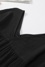 Black textured gauze blouse with gathered detail and square neckline.