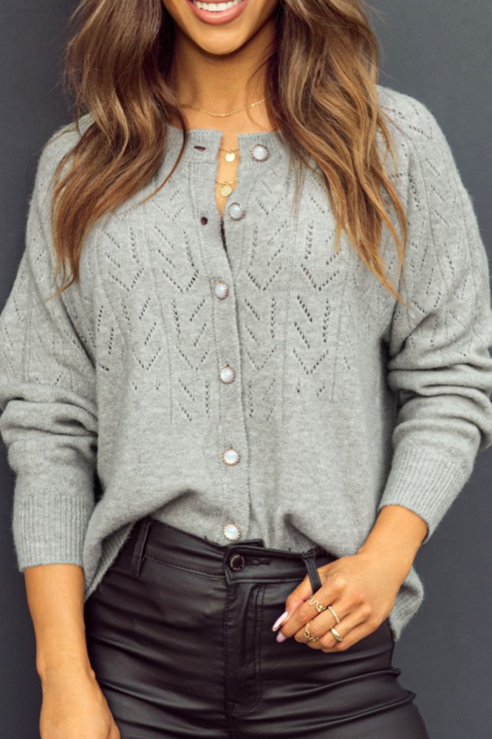 Gray lace-effect knit button-down cardigan with pearl buttons and chevron pattern.