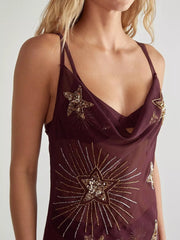 Sheer celestial star sequin cover-up dress in deep brown with cowl neck and thin straps.