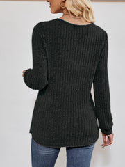 Textured ribbed V-neck pullover sweater in black with long sleeves.