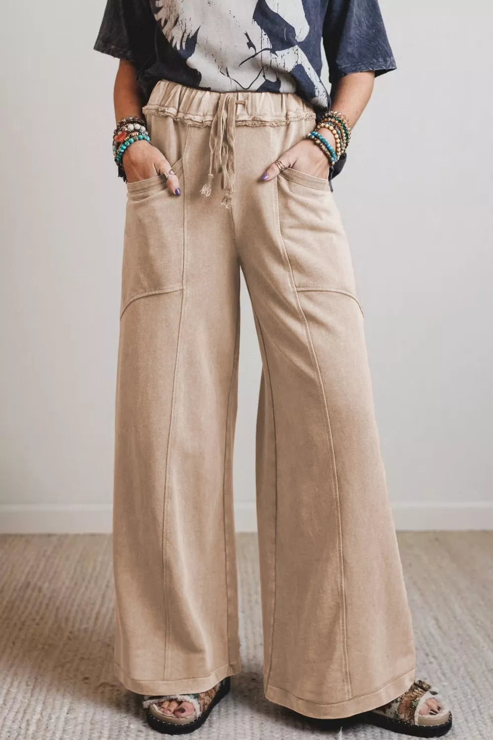 Mineral wash wide leg maternity pants in beige cotton with drawstring waist and pockets.