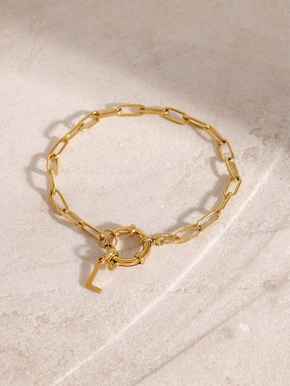 Gold chunky chain bracelet with toggle clasp and initial L charm