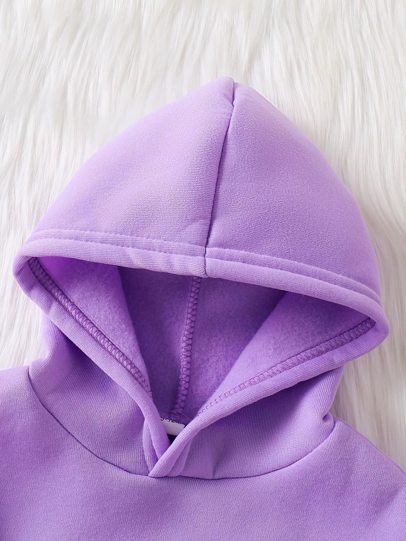 Lavender baby hoodie with fleece lining and drawstring detail.