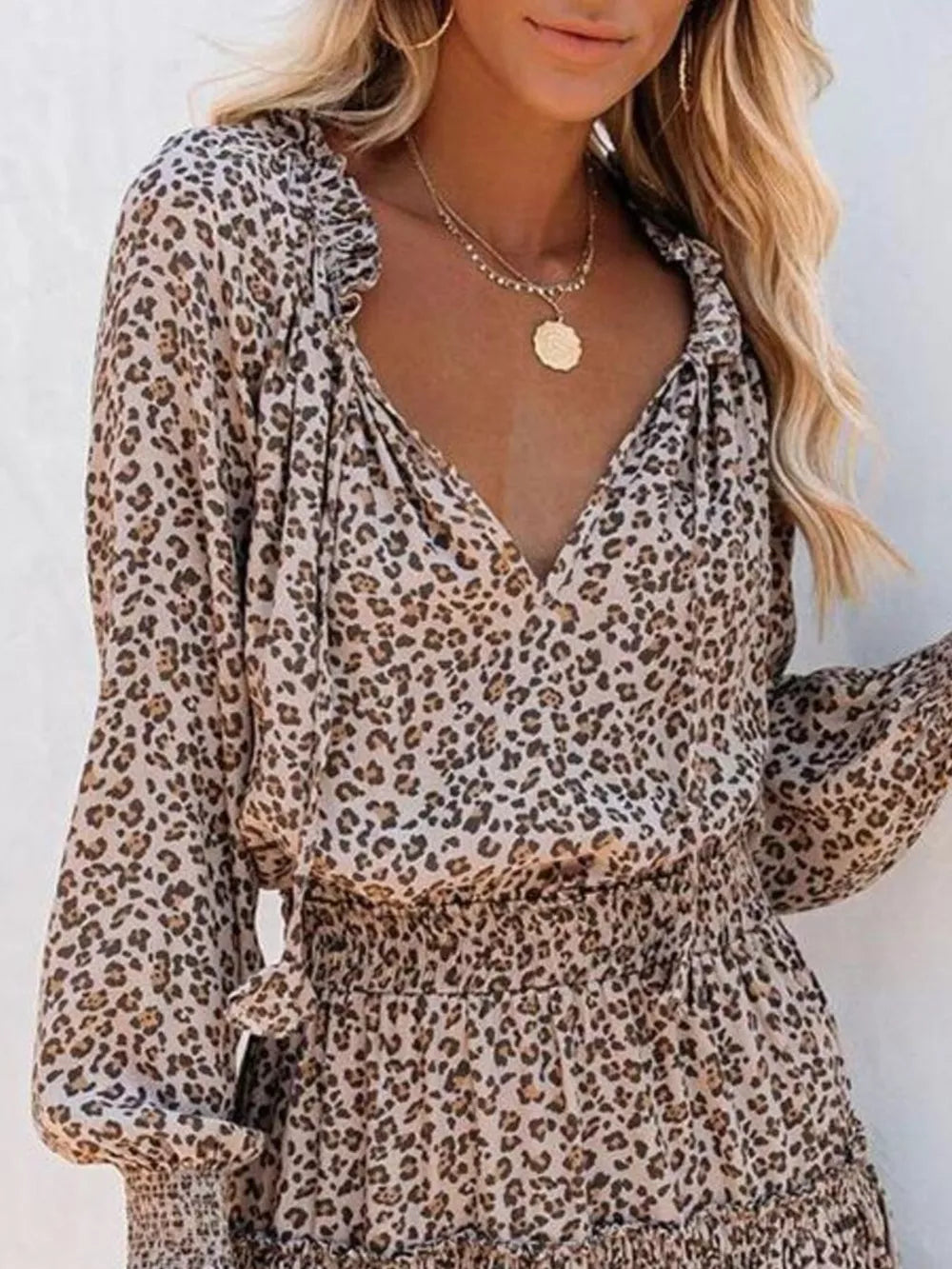 Leopard print tiered mini dress with ruffled neckline and smocked waist