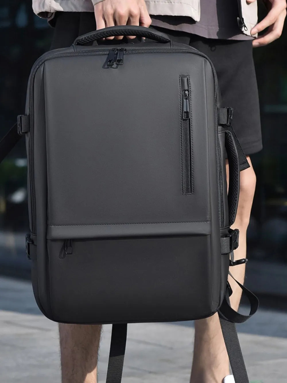 Black convertible commuter backpack with multiple zippered pockets and padded straps.