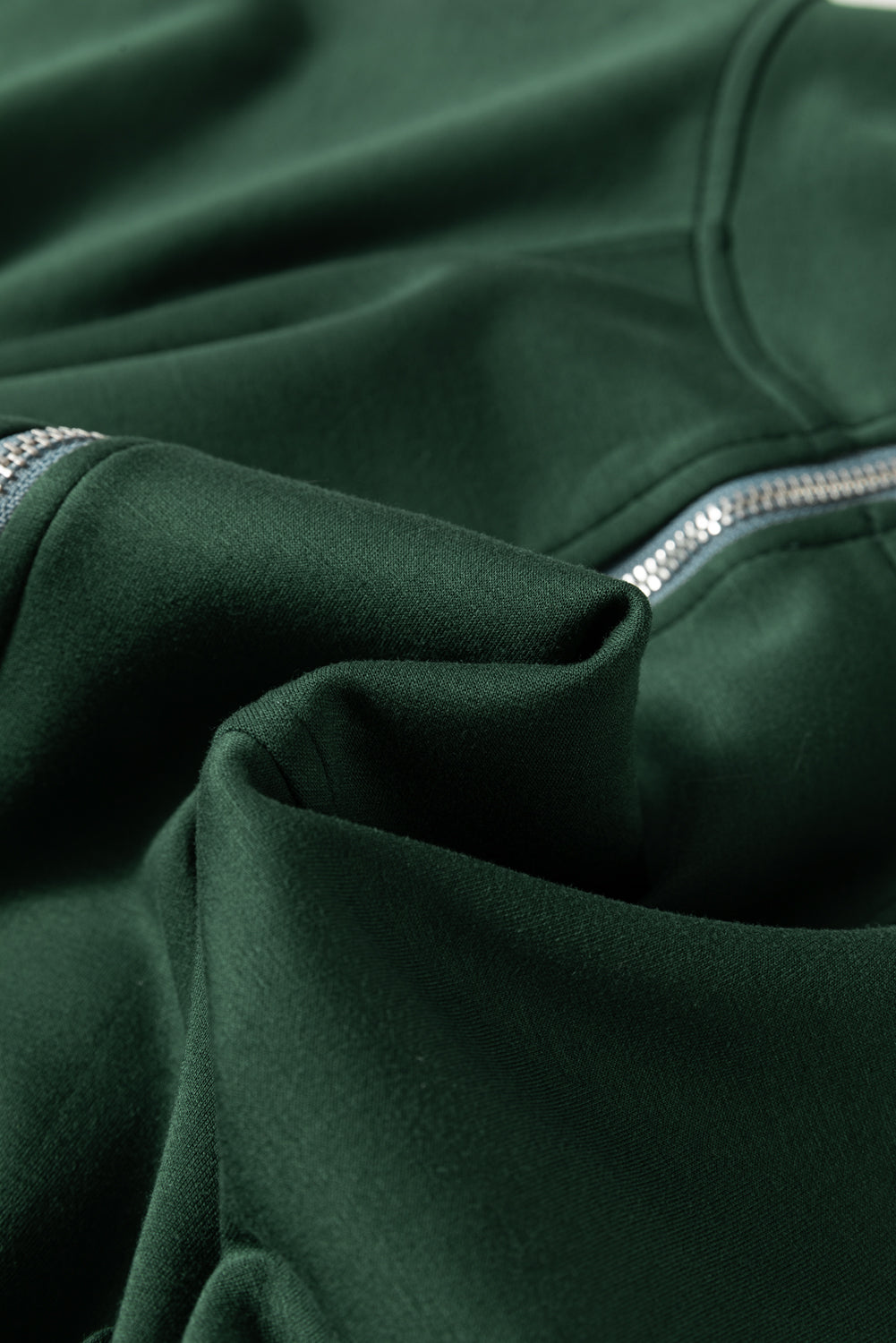 Dark green funnel neck romper with drawstring waist and zipper detail
