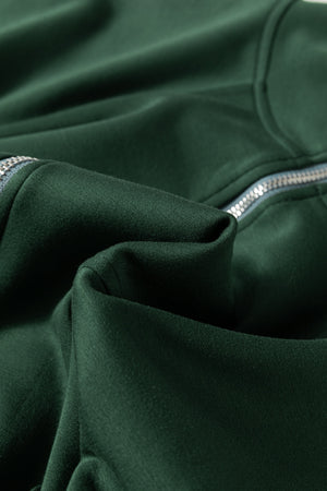 Dark green funnel neck romper with drawstring waist and zipper detail