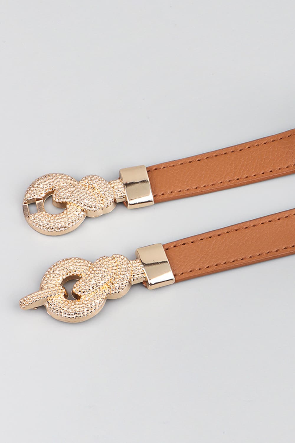 Caramel elasticated waist belt with gold knot buckle detail