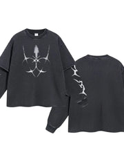Black distressed graphic long sleeve tee with layered sleeves and abstract white print.