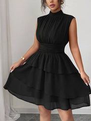 Black sleeveless tiered ruffle dress with ruched bodice and mock neck
