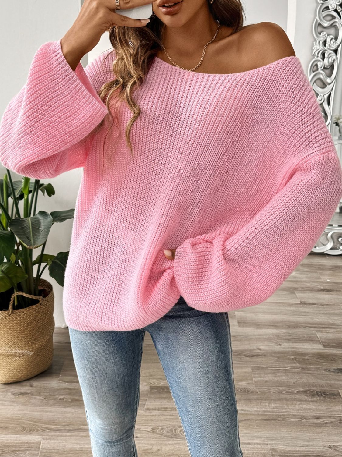 Off-the-shoulder ribbed knit pullover sweater in dusty pink with bell sleeves.
