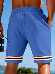 Blue textured knit drawstring shorts with pockets and striped cuffs.