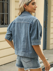 Cropped denim jacket in medium wash with puff sleeves and button details.