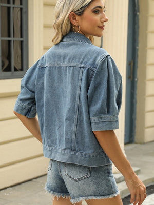 Cropped denim jacket in medium wash with puff sleeves and button details.