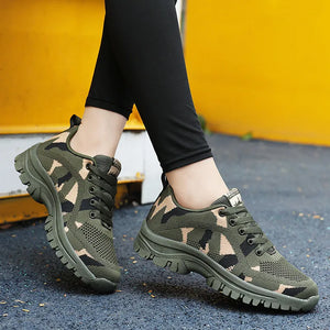 Camouflage mesh performance trainers in moss green with lace-up closure and thick soles.