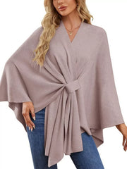 Blush pink knit cape top with V-neck and tie-front detail, draped elegance.