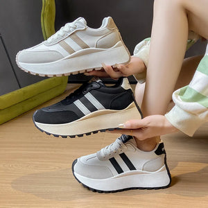 Retro stripe platform trainers in white, beige, and black with chunky soles.