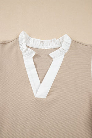 Khaki blouse with white contrast ruffle collar and V-neck detail.